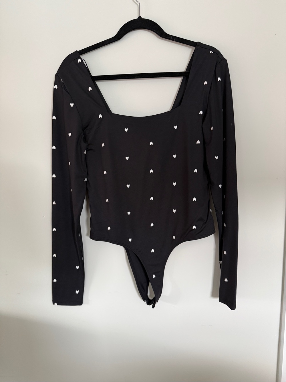 Francesca’s Black Long Sleeve Heart Print Bodysuit